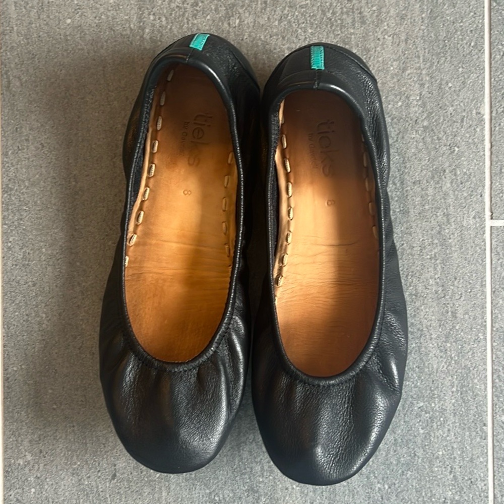 TIEKS classic black leather flats.